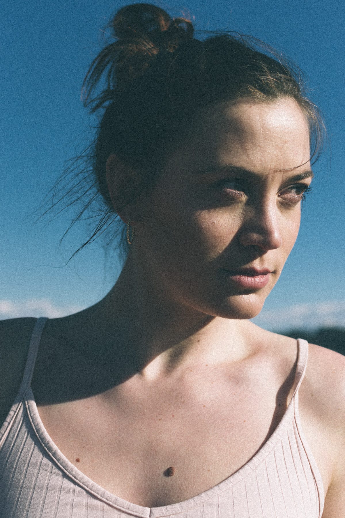 Contemplative expression in moody lighting