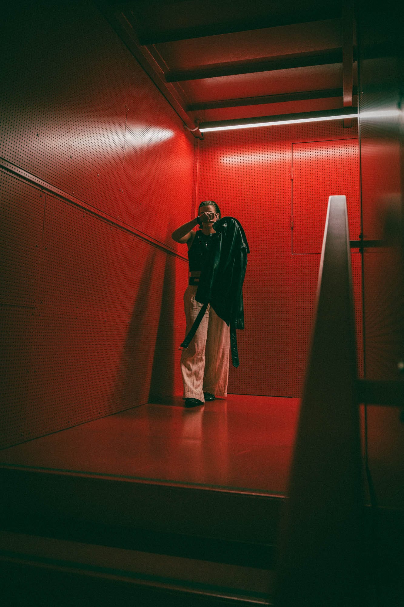 Architectural portrait with red stairs backdrop